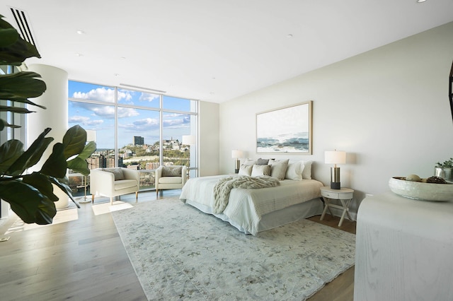 bedroom with a wall of windows and light wood-type flooring