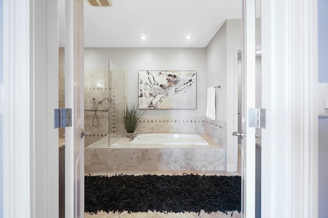 bathroom featuring shower with separate bathtub