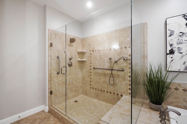 bathroom with a shower with shower door and tile patterned floors