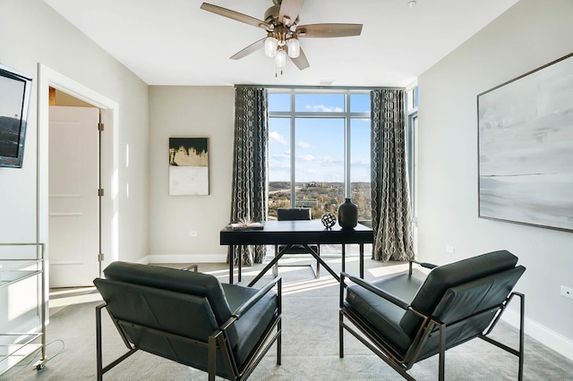 office space featuring ceiling fan, expansive windows, and a healthy amount of sunlight