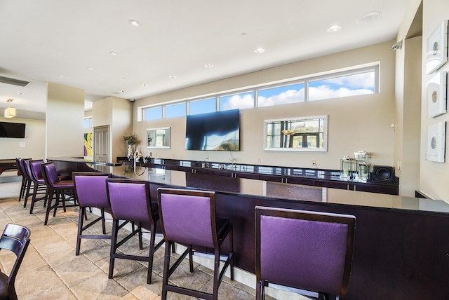 bar featuring light tile patterned floors