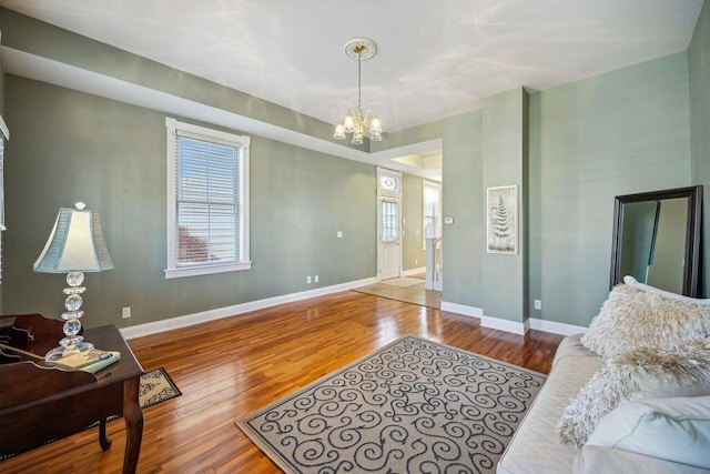 living room featuring hardwood / wood-style flooring and an inviting chandelier