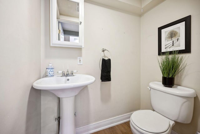 bathroom with toilet and hardwood / wood-style flooring