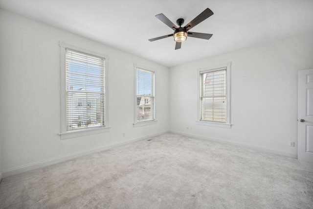 carpeted spare room with ceiling fan