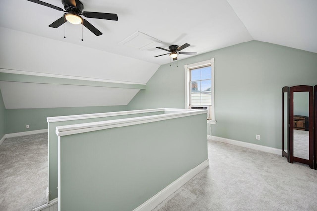 additional living space featuring ceiling fan, light carpet, and vaulted ceiling