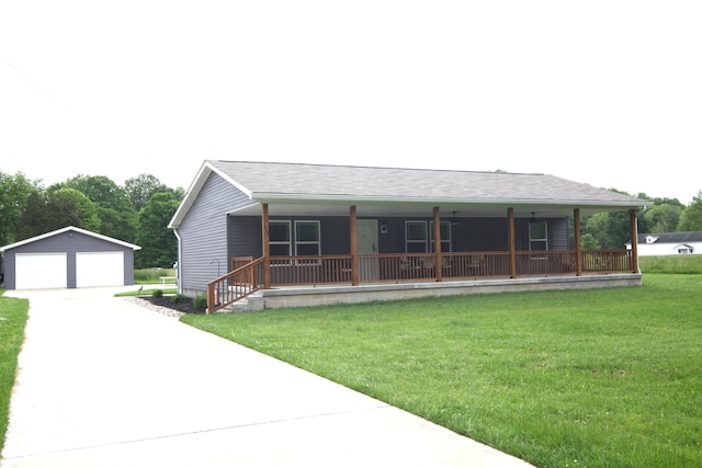 view of front of home with an outbuilding, a garage, a front lawn, and covered porch