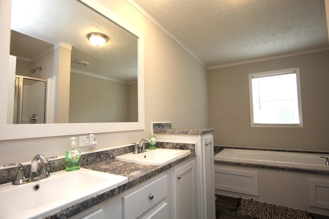 bathroom with ornamental molding, independent shower and bath, a textured ceiling, and vanity