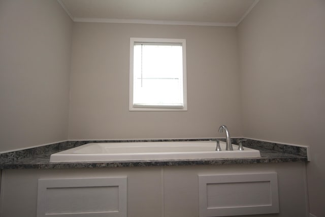 bathroom featuring sink, crown molding, and a bath