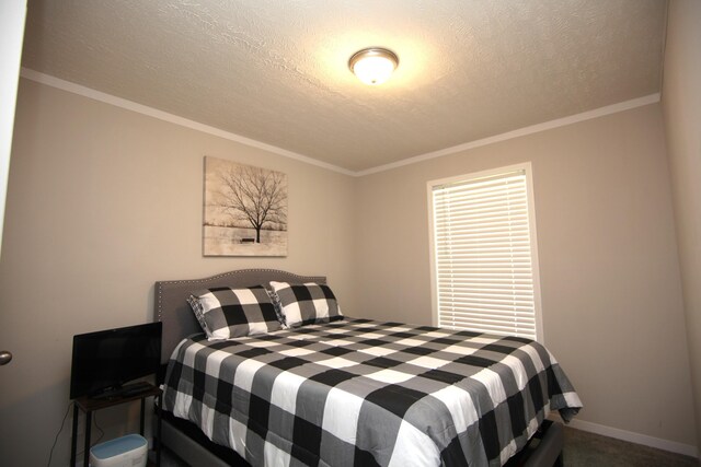 carpeted bedroom featuring crown molding and a textured ceiling