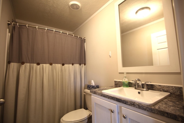 bathroom featuring ornamental molding, toilet, vanity, and a textured ceiling