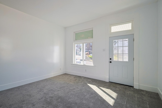 entryway with dark colored carpet