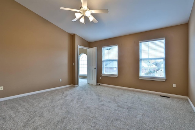 unfurnished room with ceiling fan, light colored carpet, and lofted ceiling