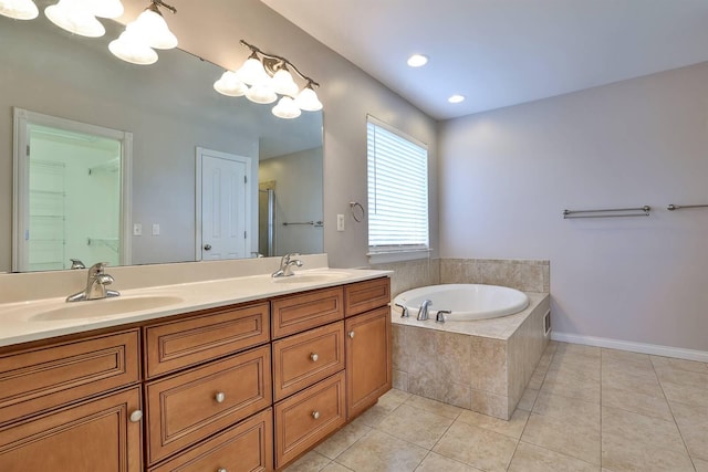 bathroom featuring tile patterned flooring, vanity, and a relaxing tiled tub