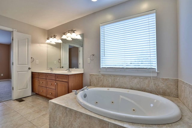 bathroom featuring vanity, tiled bath, and tile patterned floors