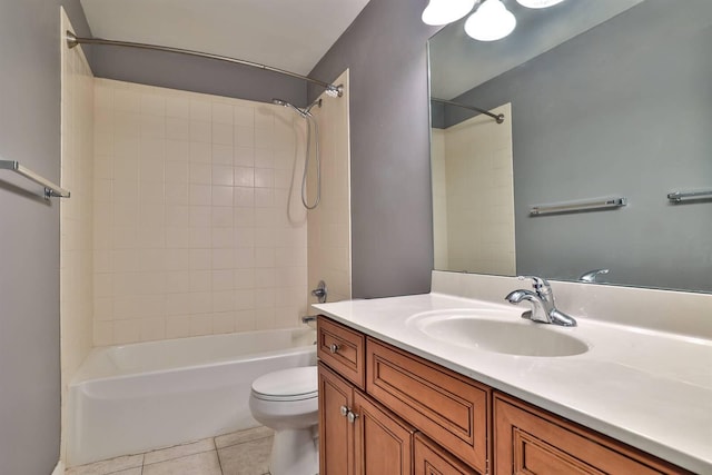 full bathroom with tile patterned flooring, vanity, tiled shower / bath combo, and toilet