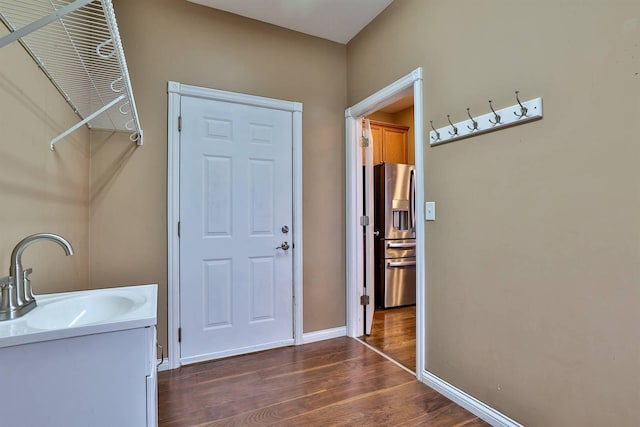 interior space with dark hardwood / wood-style floors and sink