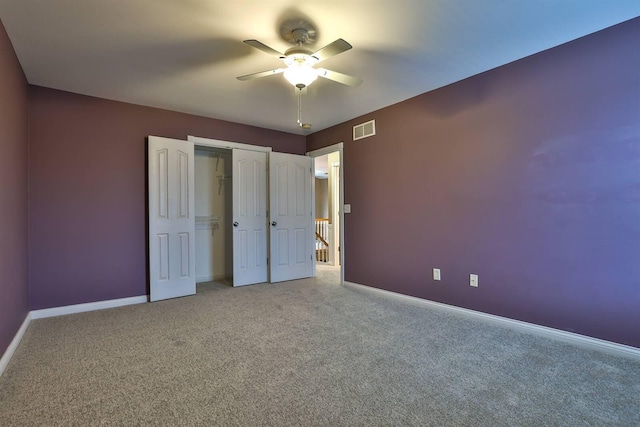 unfurnished bedroom featuring carpet, a closet, and ceiling fan