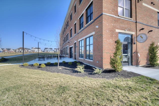 view of side of property with a yard