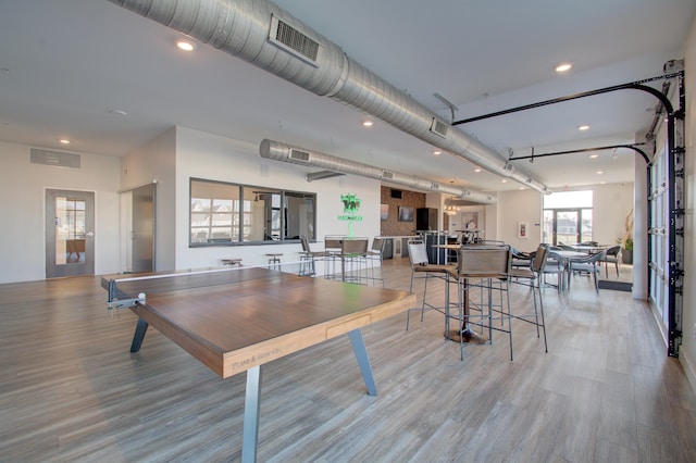 game room with light hardwood / wood-style floors