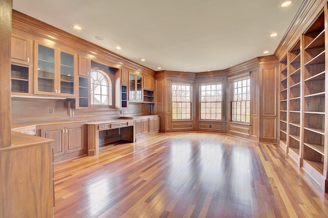 interior space with ornamental molding, light wood-type flooring, and built in study area