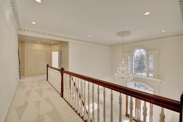 hallway featuring an upstairs landing, light carpet, ornamental molding, recessed lighting, and a chandelier