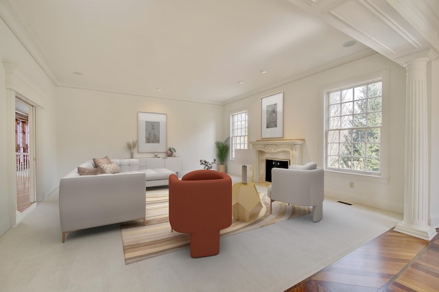 living area featuring a fireplace, visible vents, ornate columns, and ornamental molding