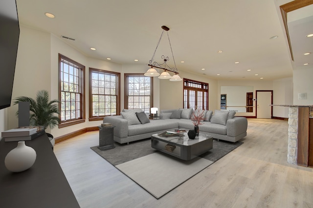 living room with recessed lighting, visible vents, and light wood finished floors