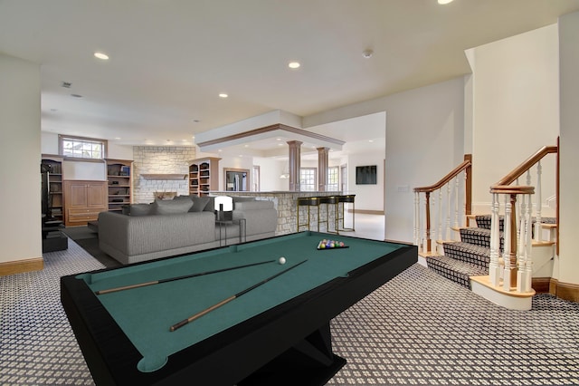 playroom featuring recessed lighting, carpet, a stone fireplace, baseboards, and ornate columns