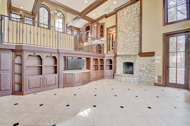 unfurnished living room with a high ceiling, a fireplace, and beamed ceiling