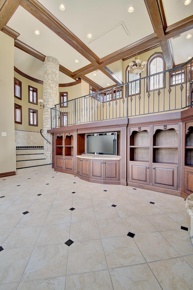 empty room with beamed ceiling, coffered ceiling, recessed lighting, a high ceiling, and decorative columns