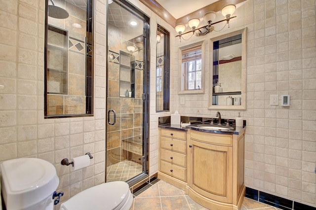 full bathroom with tile patterned flooring, toilet, a stall shower, and tile walls