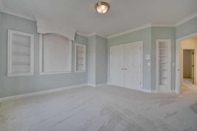 unfurnished bedroom with baseboards, ornamental molding, and carpet flooring