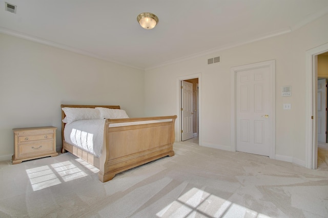 unfurnished bedroom featuring visible vents, light colored carpet, baseboards, and ornamental molding