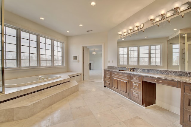 full bathroom featuring double vanity, visible vents, a garden tub, and a sink