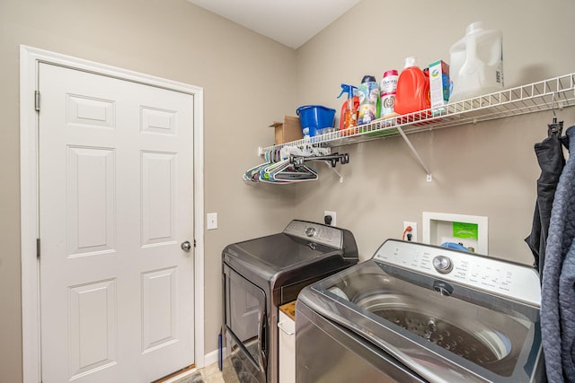 clothes washing area featuring washer and clothes dryer