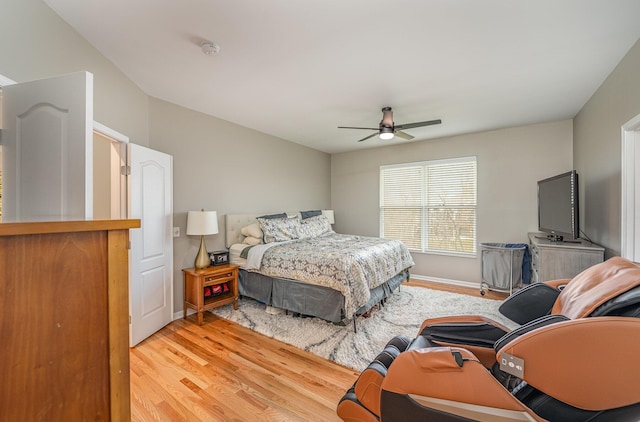 bedroom with light hardwood / wood-style floors and ceiling fan