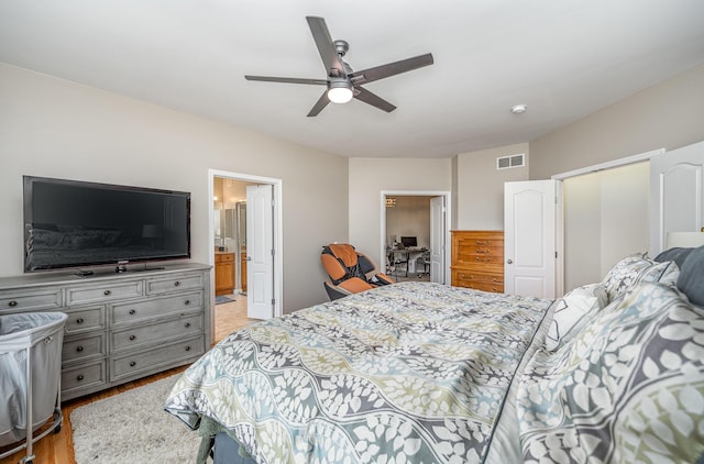 bedroom featuring connected bathroom, ceiling fan, and light hardwood / wood-style floors