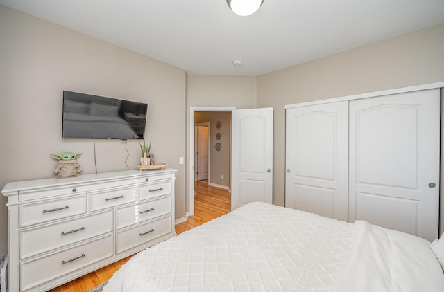 bedroom featuring light hardwood / wood-style flooring and a closet