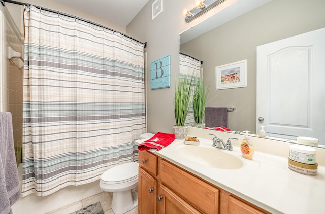 bathroom with vanity, tile patterned flooring, and toilet