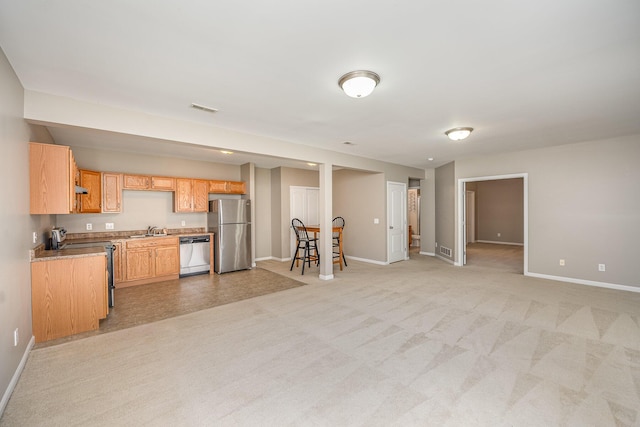 kitchen featuring sink, light colored carpet, and appliances with stainless steel finishes