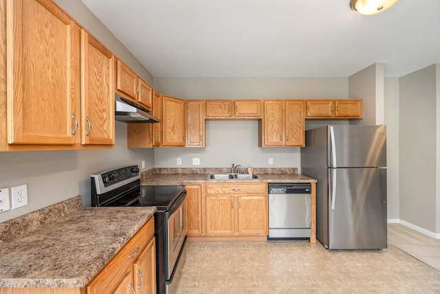 kitchen featuring appliances with stainless steel finishes, sink, and dark stone counters