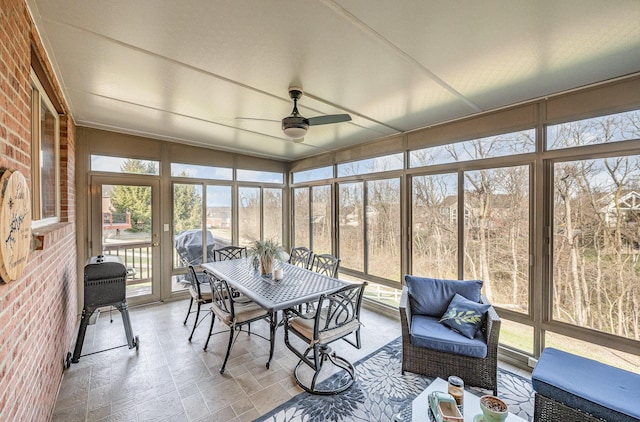 sunroom / solarium featuring ceiling fan