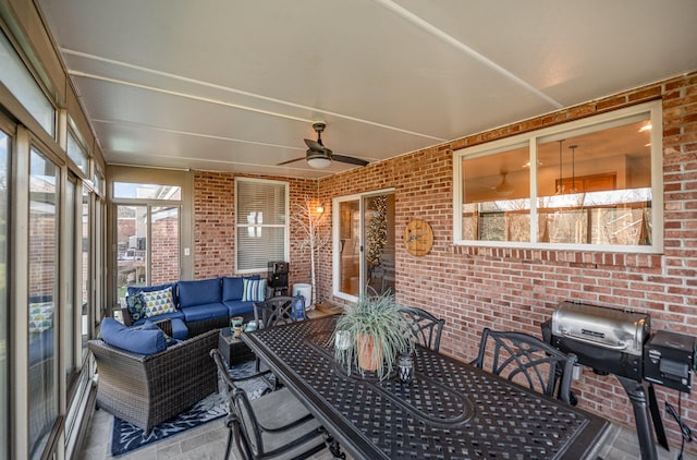 sunroom / solarium featuring ceiling fan