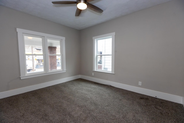 unfurnished room featuring ceiling fan, carpet floors, and a healthy amount of sunlight