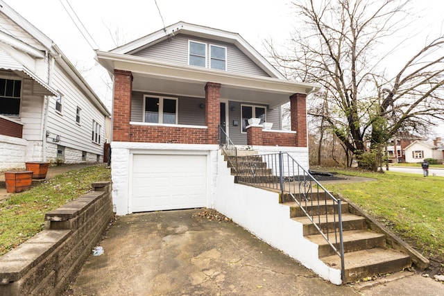 bungalow-style home featuring a garage and a front lawn