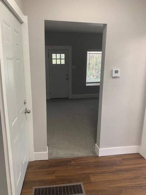 corridor with dark colored carpet