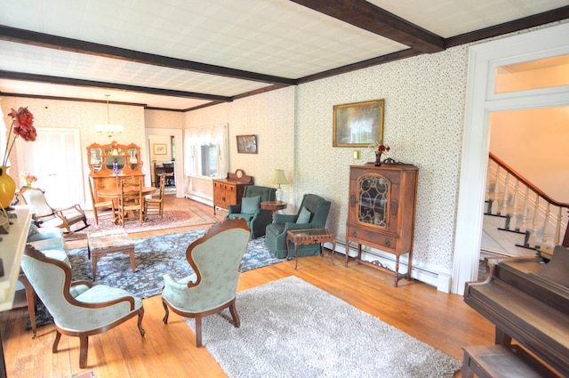 living room with a chandelier, beam ceiling, hardwood / wood-style flooring, and a baseboard radiator