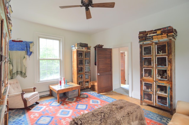 living area featuring baseboard heating and ceiling fan