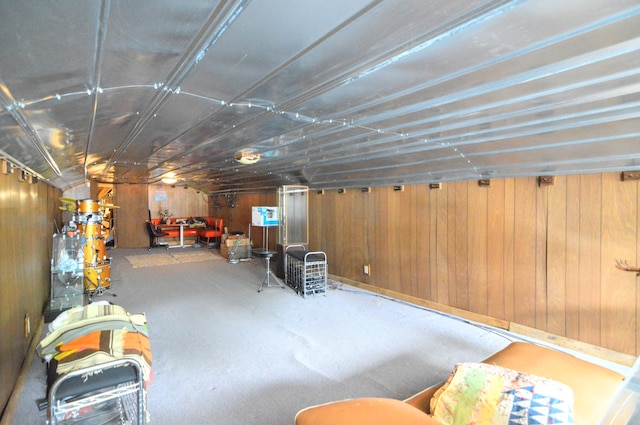 basement featuring wooden walls