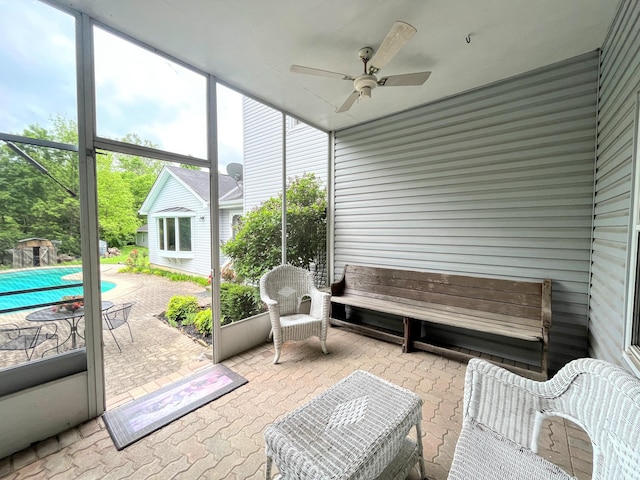 sunroom / solarium featuring ceiling fan